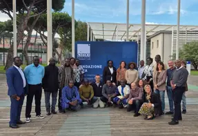 Group photo of around 25 people taken outside.
